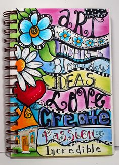 a spiral notebook with an image of flowers and the words art is love created inside