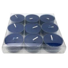 twelve blue candles in a clear box