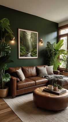 a living room with green walls and leather furniture