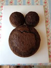 a chocolate mickey mouse cookie on a white plate