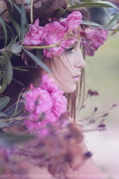 a woman with pink flowers in her hair