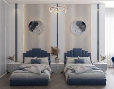 two beds in a room with blue and white decor