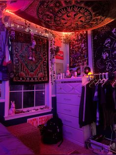 a room filled with lots of purple lights and wall hangings on the walls next to a window