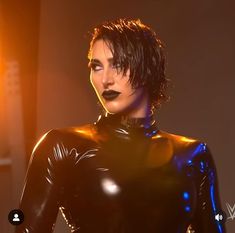 a woman in black latex posing for the camera