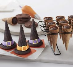 there are many cones with witches hats on them and some cookies in the shape of ice cream cones