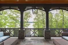 a covered porch with couches and tables on it