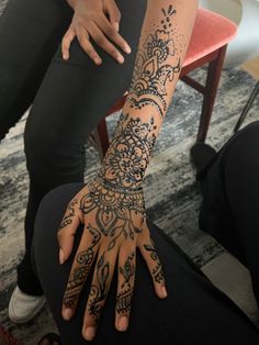 a woman's arm and hand covered with hendix tattoo designs on it