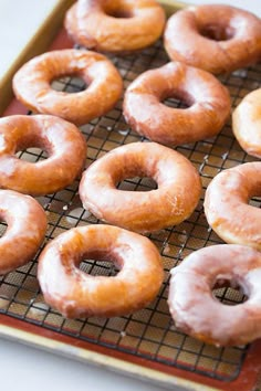 glazed donuts are on a cooling rack ready to be baked in the oven,