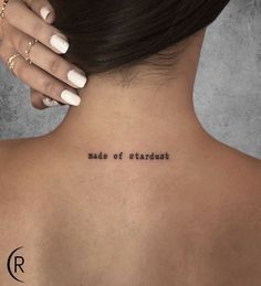 the back of a woman's neck with an inscription on it