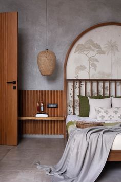 a bed sitting in a bedroom next to a wooden headboard