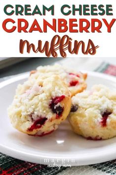 two cranberry muffins on a white plate with the words cream cheese cranberry muffins