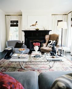 a living room filled with furniture and a fire place