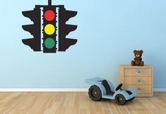 a child's room with a wall decal that has a traffic light on it