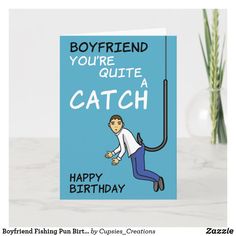 a birthday card with a cartoon man dangling from a hook and caption boyfriend you're quite a catch happy birthday