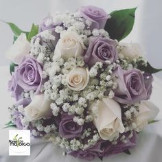 a bridal bouquet with white and purple flowers