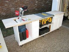 a white table with tools on it in front of a brick wall