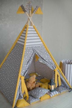 a teepee tent with a teddy bear in it