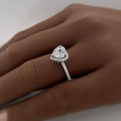 a woman's hand with a diamond ring on it