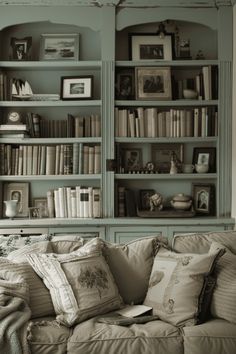 a living room filled with lots of books and furniture