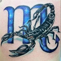 a scorpion tattoo on the back of a woman's upper arm with an arrow