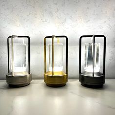 three different types of lights sitting on top of a white table next to each other