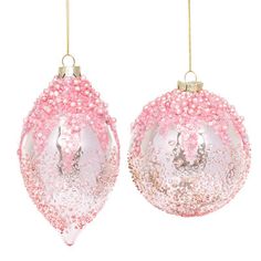 two pink and white ornaments hanging from strings