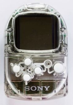 an electronic device with buttons on the front and back sides, sitting on a white surface