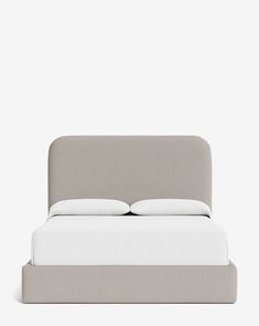 an upholstered bed with white sheets and pillows on the headboard, against a gray background