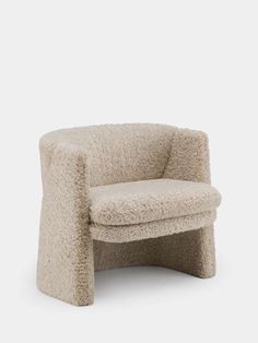 the chair is made out of sheepskin and has a rounded seat that sits on one end