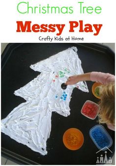 a child is making a christmas tree messy play craft with plastic cups and glue