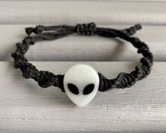 This glow in the dark bracelet is adjustable and fits most sizes. The Alien bead glows green in the dark. The Alien bead measures approximately 3/4" X 1/2". *Items are handmade and may vary slightly from the photo.* Dark Bracelet, Gray Alien, Grey Alien, Hemp Bracelet, Hemp Bracelets, Braided Bracelets, Helix, In The Dark, Glow In The Dark