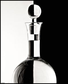 a black and white photo of a glass bottle