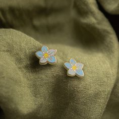 Forget Me Not earrings in pastel blue offer a delicate and charming nod to these symbolic flowers, ensuring you’re remembered just as fondly as their namesake. Ideal for adding a subtle splash of color and meaning to your style. Enamel earring with polished gold-plated metal, featuring stainless steel posts with 0.5" (13 mm) extra-long design for secure, stable wear, paired with silicone cone backs for a snug fit. Features 10x6mm full-cover, dust-proof studs. Details: One pair of stud earrings P Forget Me Not, Enamel Earrings, Pastel Blue, Wedding Anniversary, Color Splash, Plating, Stud Earrings, Gift Card, Gold