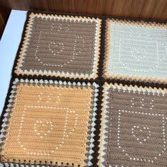 there is a crocheted blanket with squares on the bottom and one square in the middle