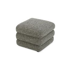 the footstool is made out of grey fabric