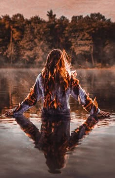 a woman is sitting in the water with her hands on her hips and looking into the distance