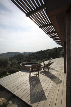 two chairs sitting on top of a wooden deck