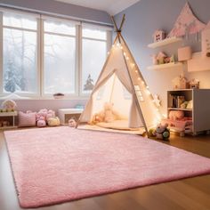 a child's bedroom with a teepee tent in the corner and pink rug on the floor