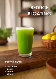 a green drink sitting on top of a wooden table