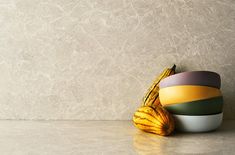 a stack of colorful bowls sitting on top of a counter next to a ripe banana