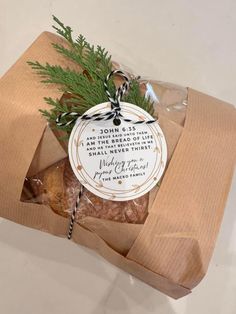 a package with some food in it on top of a white tablecloth and brown wrapping paper