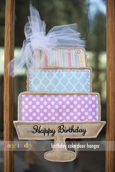 a birthday cake is displayed in a glass case with the words happy birthday written on it