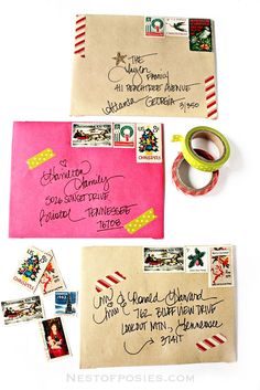 two envelopes with some writing on them next to a pair of washi tape