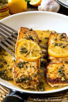 grilled fish with capers and lemon sauce on a plate