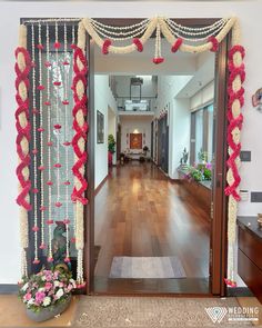 an entrance decorated with red and white garlands