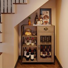 a cabinet filled with bottles and glasses next to a stair case