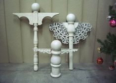 two white candlesticks sitting next to each other on top of a cement floor