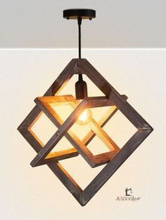 a wooden light hanging from the ceiling with a small light bulb in it's center