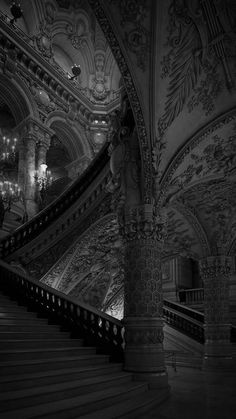 an ornate staircase in a building with chandeliers