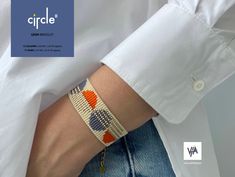 a person wearing a bracelet with an orange and blue design